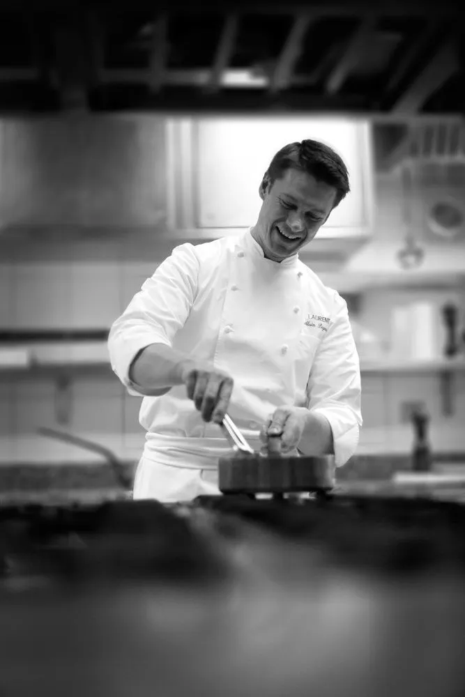 Chef preparing a dish in a working kitchen